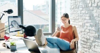 Is your CRM Database Compliant with Data Security Regulations? An image of a person using a crm database to make a phone call.